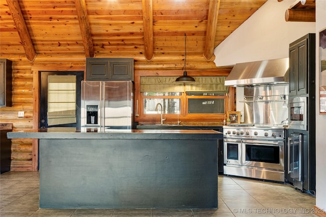 kitchen with appliances with stainless steel finishes, beamed ceiling, rustic walls, exhaust hood, and wooden ceiling