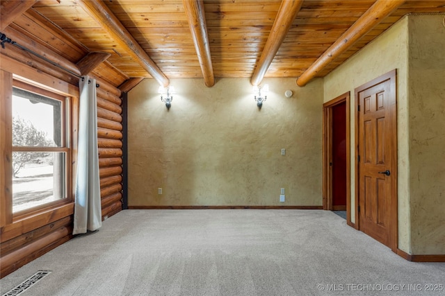 carpeted spare room featuring wood ceiling, rustic walls, and beamed ceiling