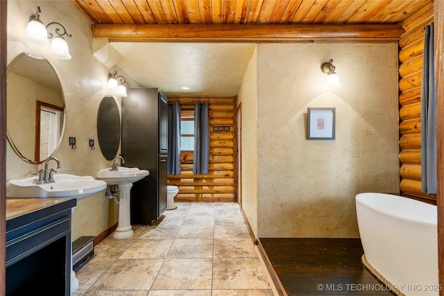 bathroom featuring log walls, a bathtub, double sink, wooden ceiling, and beam ceiling