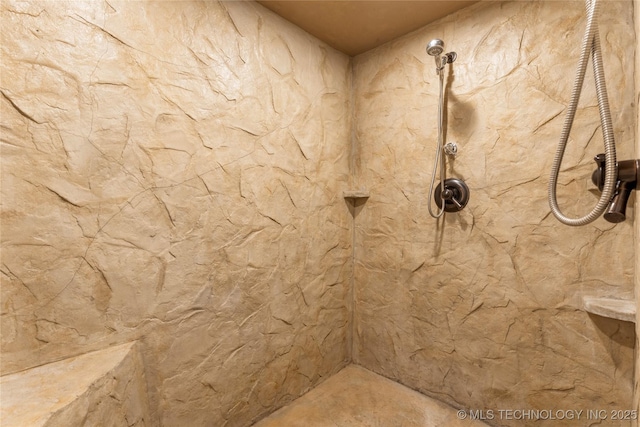 bathroom with a tile shower