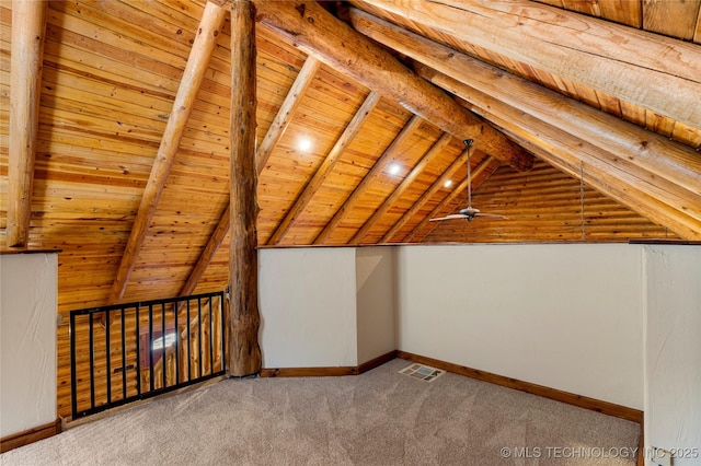 additional living space with vaulted ceiling with beams, ceiling fan, light colored carpet, and wooden ceiling