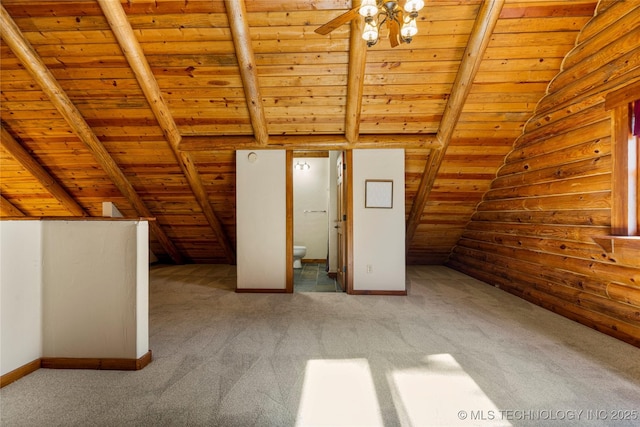 additional living space featuring vaulted ceiling with beams, light colored carpet, and wood ceiling