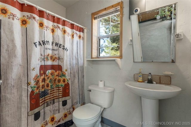 bathroom with sink, toilet, and walk in shower