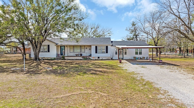 ranch-style home with a front yard and covered porch