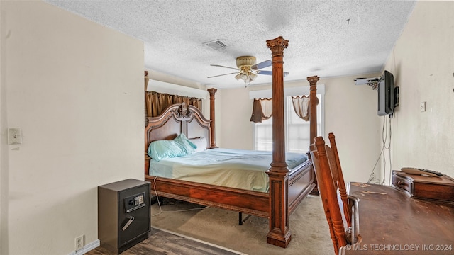 bedroom with hardwood / wood-style floors, a textured ceiling, and ceiling fan