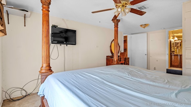 carpeted bedroom with ceiling fan and ensuite bath