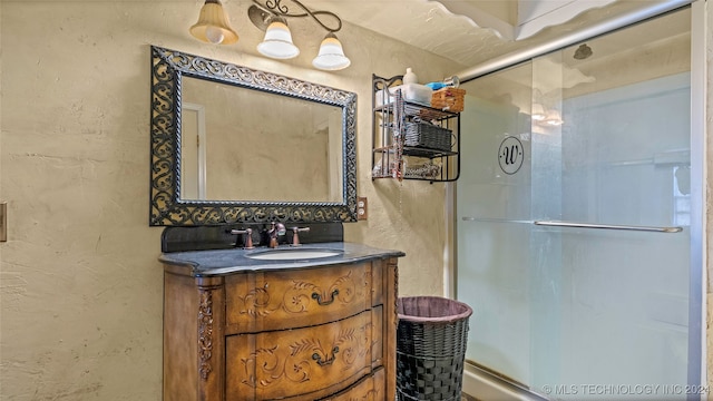 bathroom with vanity and a shower with shower door