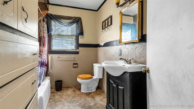 bathroom with tile walls, toilet, a washtub, vanity, and crown molding