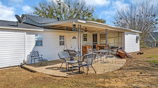 rear view of property with ceiling fan and a patio area