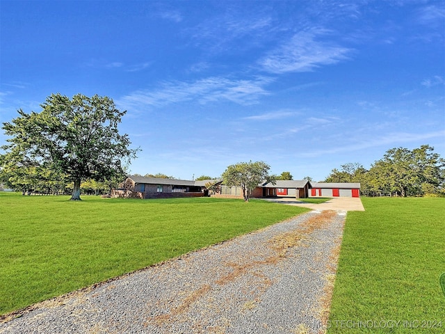 single story home featuring a front yard and a garage