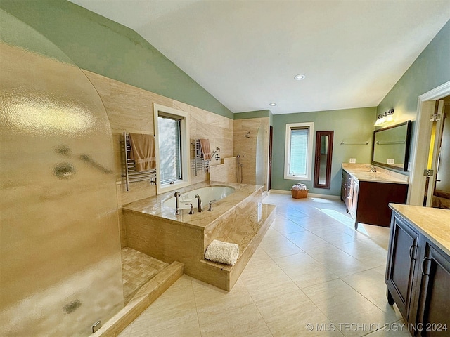 bathroom with vanity, vaulted ceiling, separate shower and tub, and tile patterned flooring