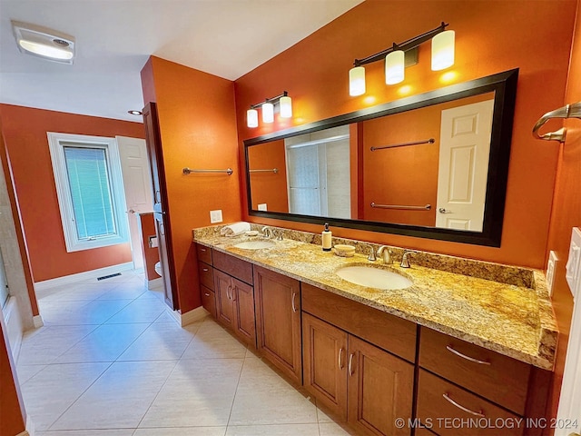 bathroom with vanity, tile patterned flooring, toilet, and a shower with door