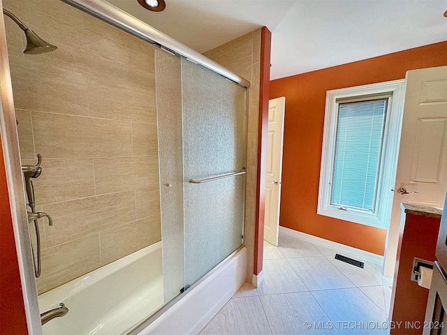 bathroom with vanity, tile patterned floors, and combined bath / shower with glass door