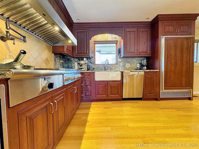 kitchen with dishwasher, decorative backsplash, range hood, sink, and light hardwood / wood-style floors