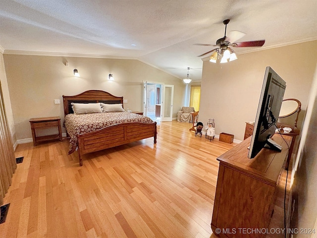 bedroom featuring wood-type flooring, a textured ceiling, ceiling fan, lofted ceiling, and crown molding