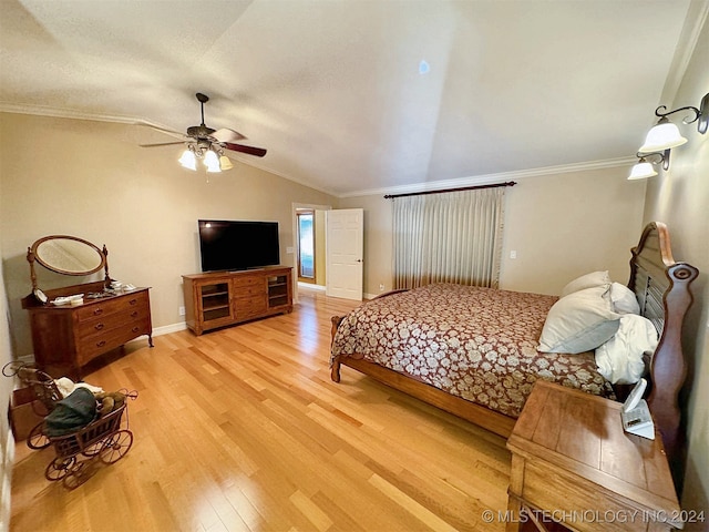 bedroom featuring crown molding, vaulted ceiling, light wood-type flooring, and ceiling fan