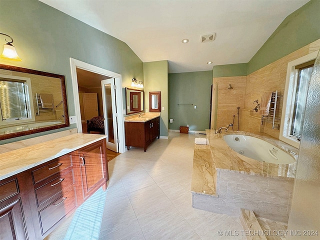 bathroom with shower with separate bathtub, radiator, lofted ceiling, vanity, and tile patterned flooring