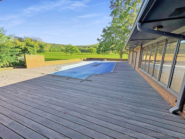 exterior space with a wooden deck and a lawn