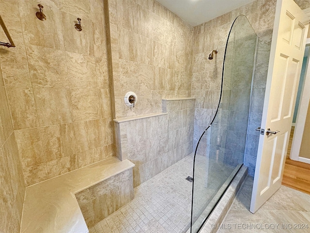 bathroom with a tile shower