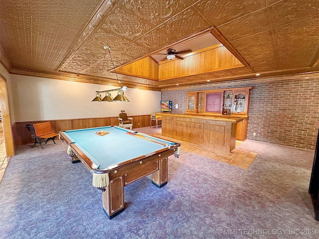 playroom featuring crown molding, dark colored carpet, and wood walls