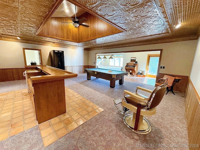 recreation room with wooden walls and crown molding