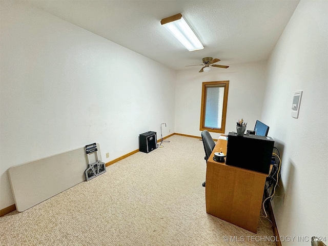 home office featuring carpet, a textured ceiling, and ceiling fan