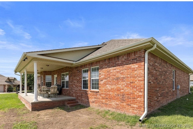 view of side of property featuring a patio area