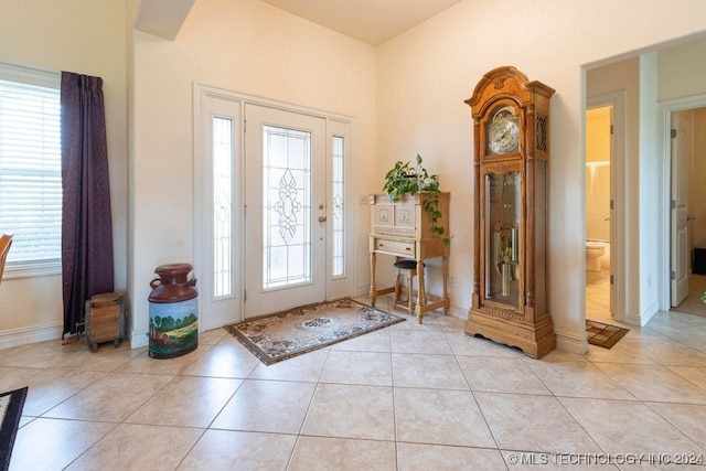 entryway with light tile patterned floors and a wealth of natural light