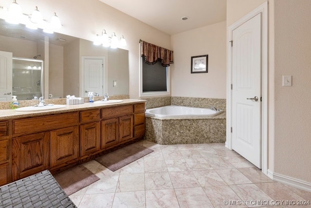 bathroom with vanity and separate shower and tub