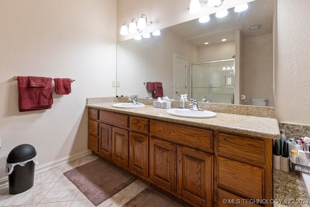 bathroom with vanity, tile patterned floors, toilet, and an enclosed shower