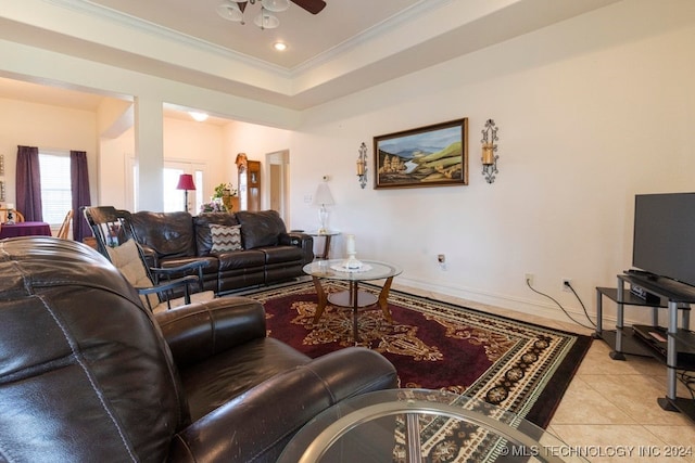 tiled living room featuring crown molding, a raised ceiling, and ceiling fan