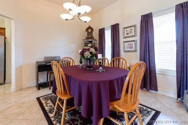 dining space featuring a notable chandelier and light tile patterned floors