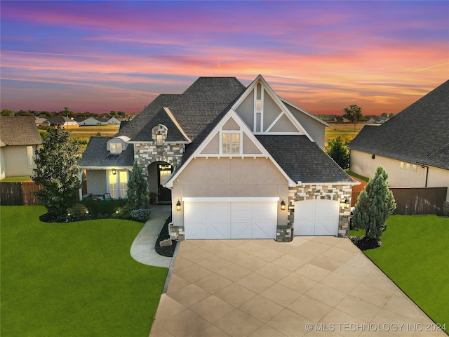 view of front of property featuring a yard and a garage