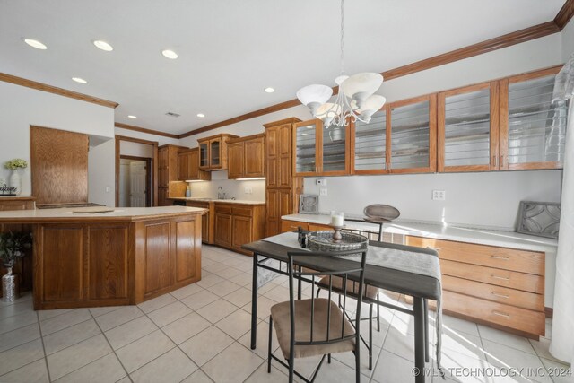 kitchen with light tile patterned flooring, ornamental molding, a chandelier, and decorative light fixtures