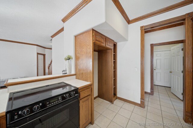 kitchen featuring ornamental molding, light tile patterned floors, and black range oven