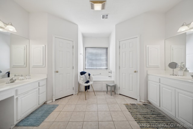 bathroom featuring vanity, tile patterned floors, and a bathing tub