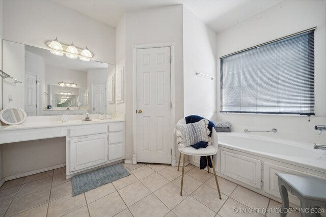 bathroom featuring vanity, a tub to relax in, and tile patterned floors