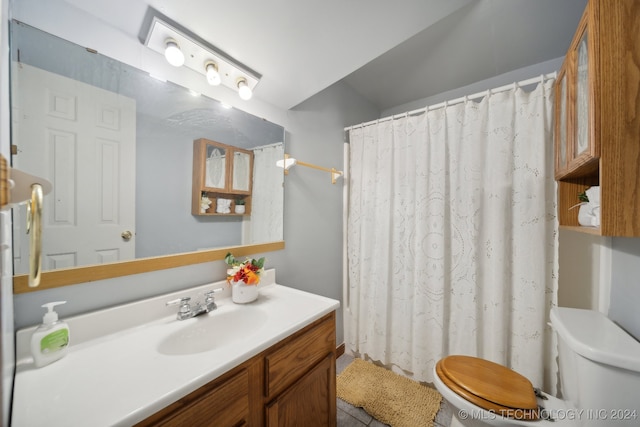 bathroom with toilet, vanity, and a shower with shower curtain