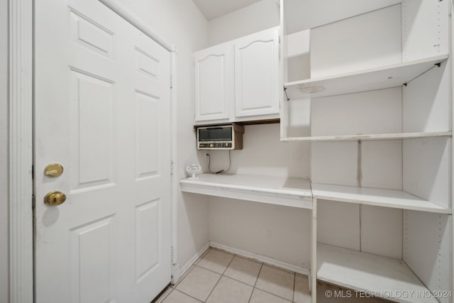 unfurnished office with light tile patterned floors