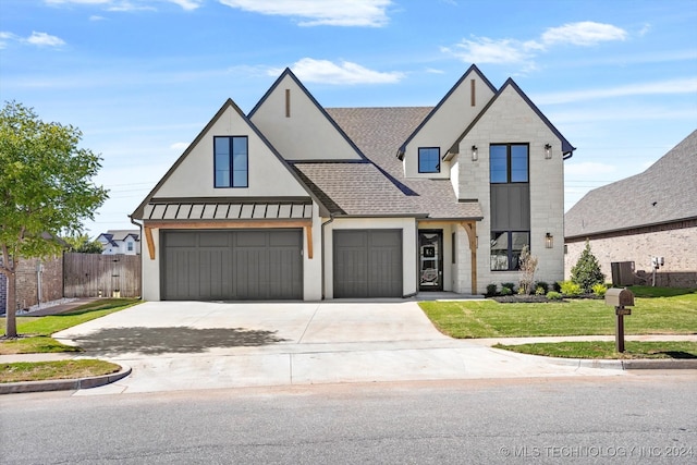 view of front facade with a front yard and a garage