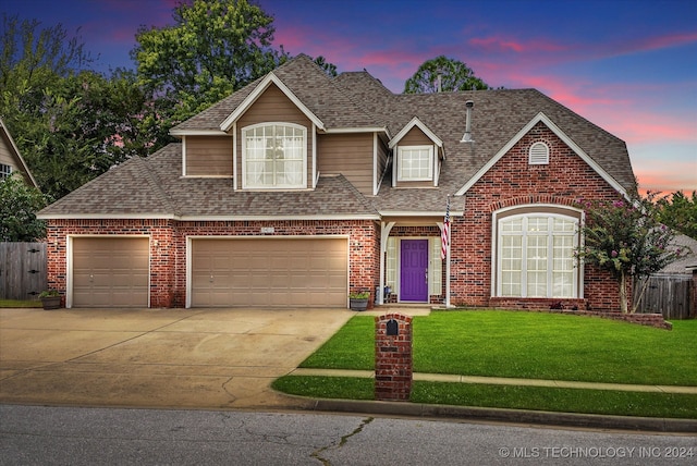 view of front of home featuring a yard and a garage