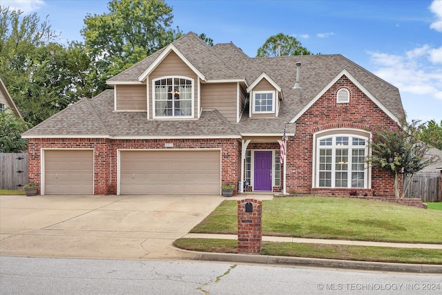 view of front of home featuring a front lawn and a garage