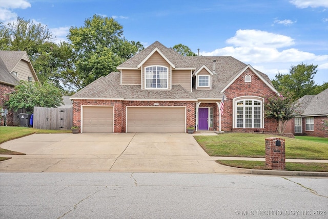 view of front of property with a front lawn and a garage