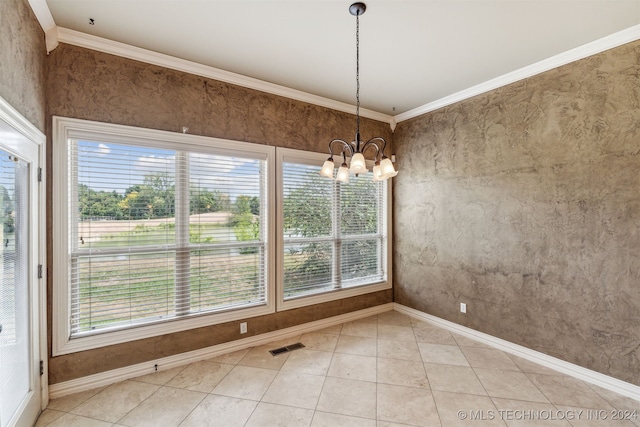 unfurnished dining area with ornamental molding, a chandelier, and tile patterned floors