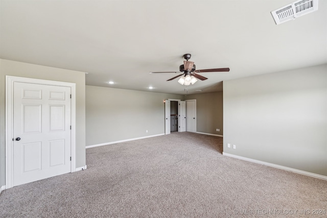 carpeted spare room featuring ceiling fan