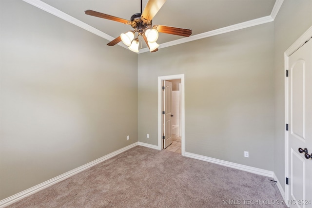 carpeted empty room featuring ceiling fan and ornamental molding