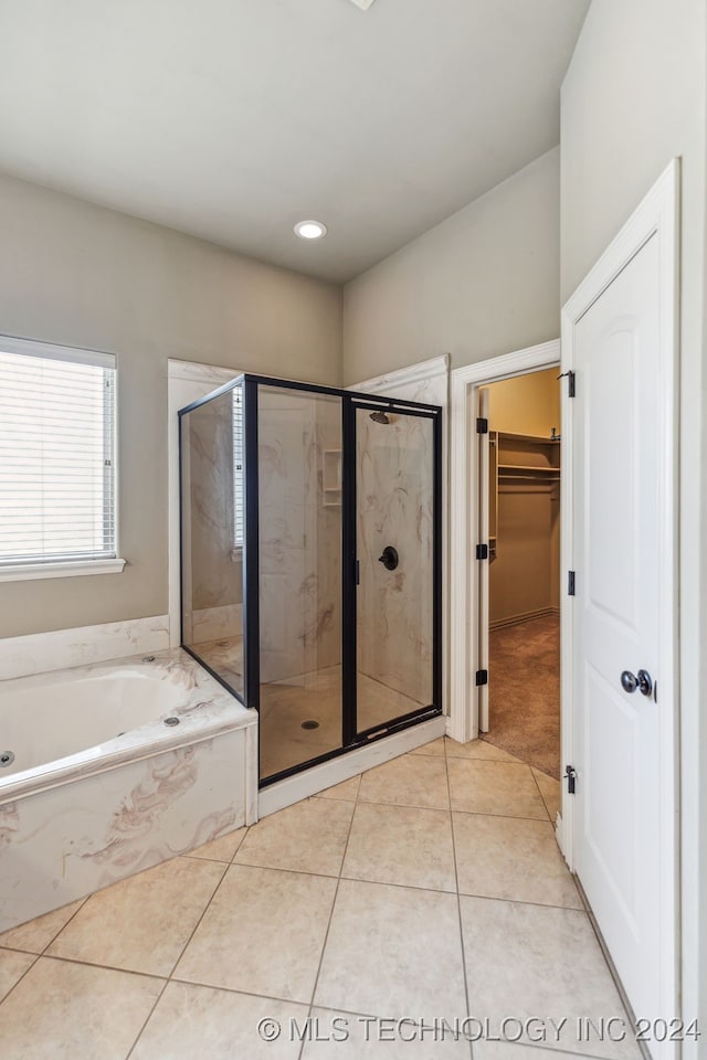 bathroom with shower with separate bathtub and tile patterned floors