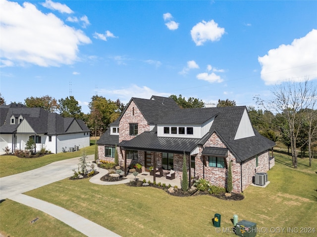 view of front of home with central air condition unit, covered porch, and a front lawn