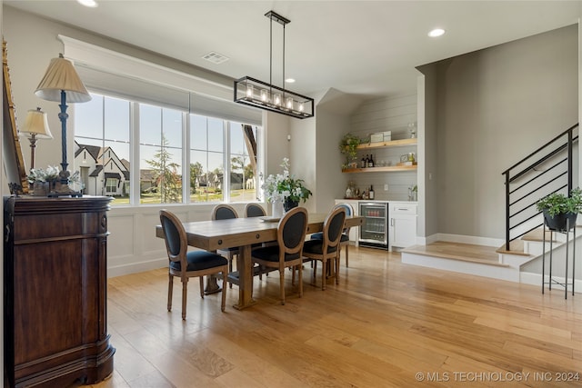 dining area featuring light hardwood / wood-style floors and beverage cooler