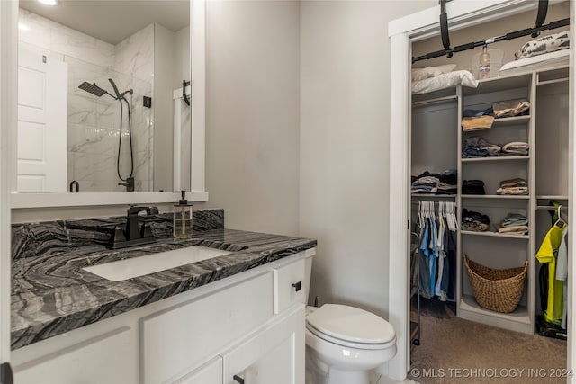 bathroom featuring vanity, toilet, and walk in shower